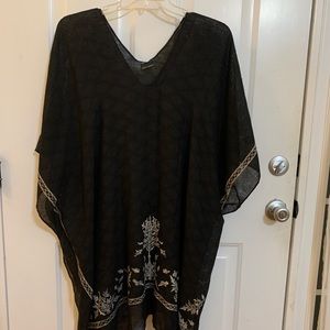 black poncho with ivory details. O/S. Hand wash. 90% polyester 20% viscose